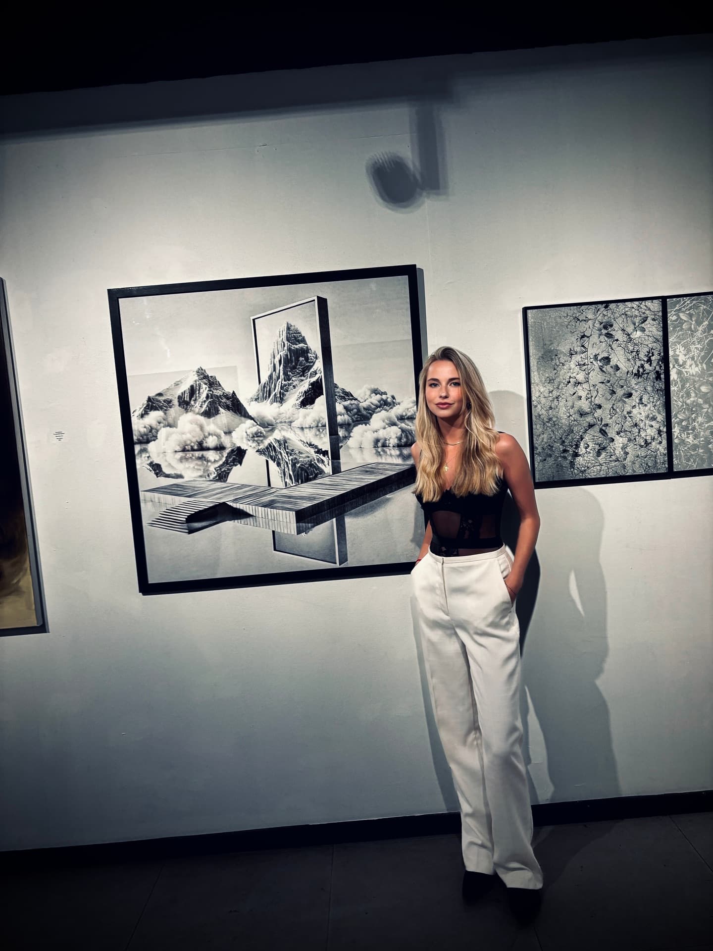 Dominique Piessevaux next to one of her works at an exhibition.